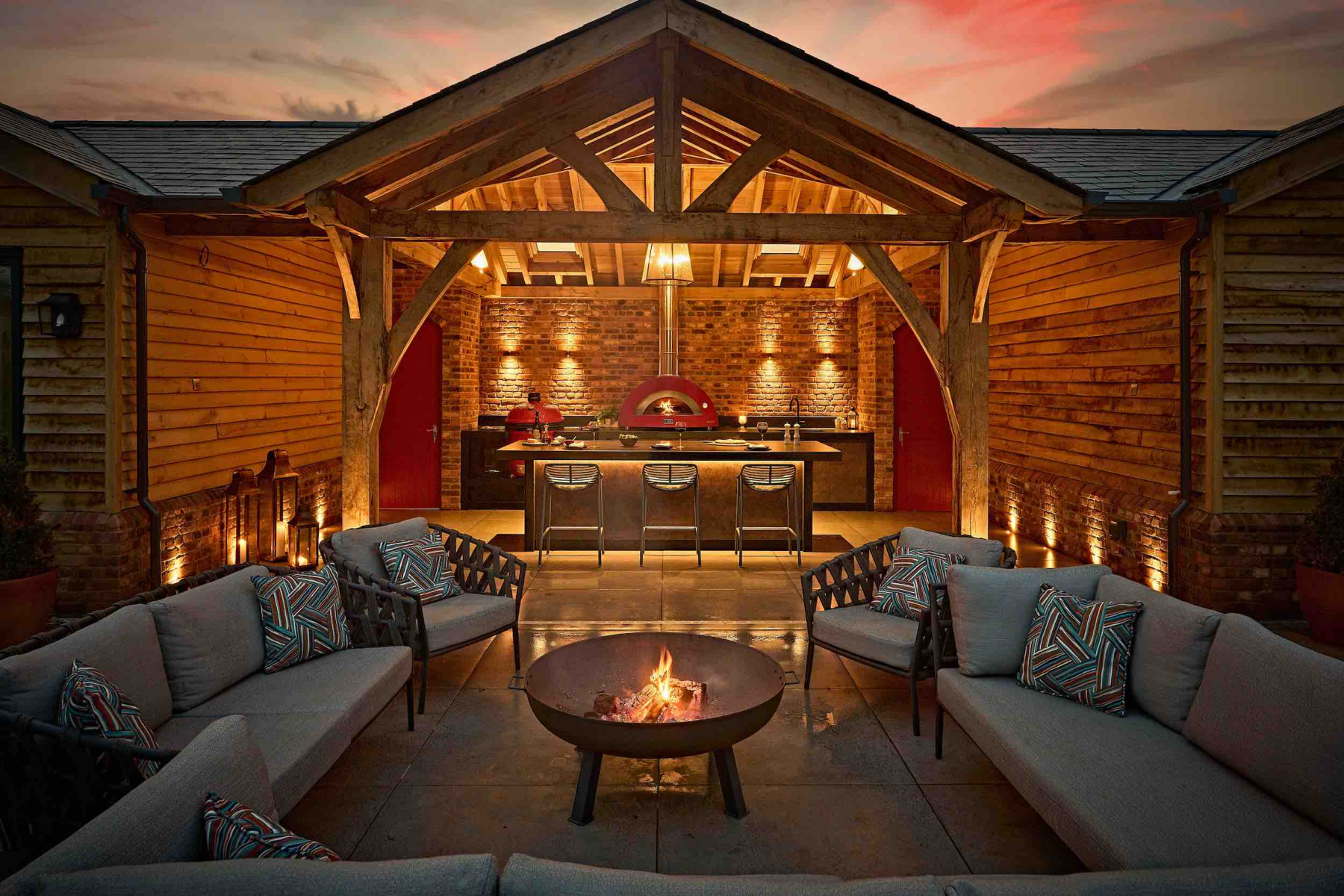 Nureno Luxury outdoor kitchen with oak-framed gazebo, pizza oven, fire pit and outdoor seating area, designed and built by Nureno in Berkshire| Design | Build | Renovation | Kitchens & Bathrooms | Outdoor Kitchens & Landscaping