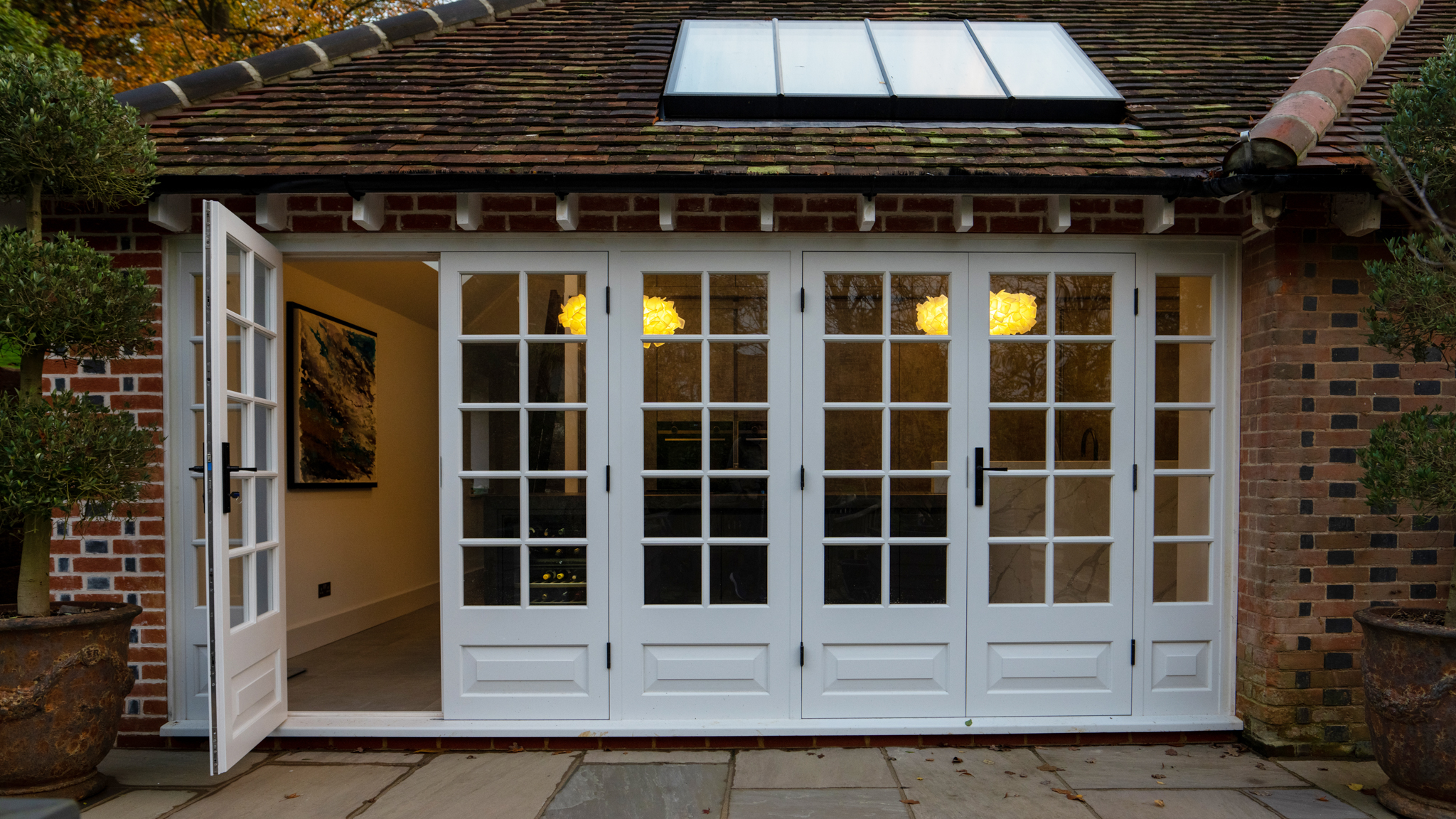 Bespoke home extension with white French doors and rooflight, built by Nureno in Berkshire