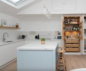 Bespoke kitchen with marble island, integrated pantry cupboard and bespoke cabinetry, designed and built by Nureno in Oxfordshire