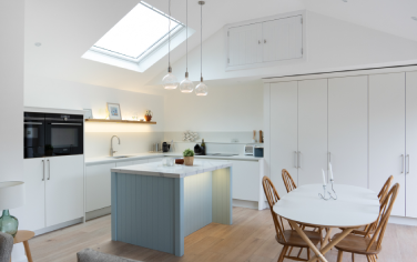 A modern kitchen transformation creating a bright open-plan space with bespoke cabinetry.